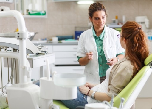 Dentist talking to a patient in the dental chair