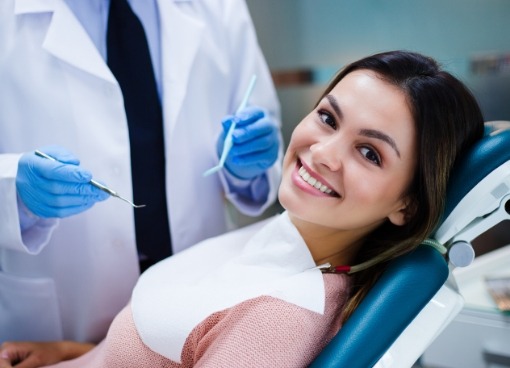 Young woman smiling while leaning back in dental chair