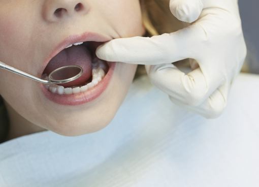 Dentist giving a child a dental exam