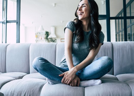 Young woman sitting on a couch and smiling