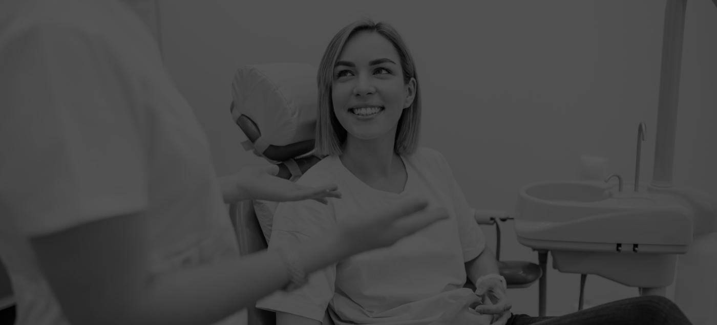 Woman smiling while talking to her dentist