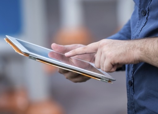 Person typing on tablet