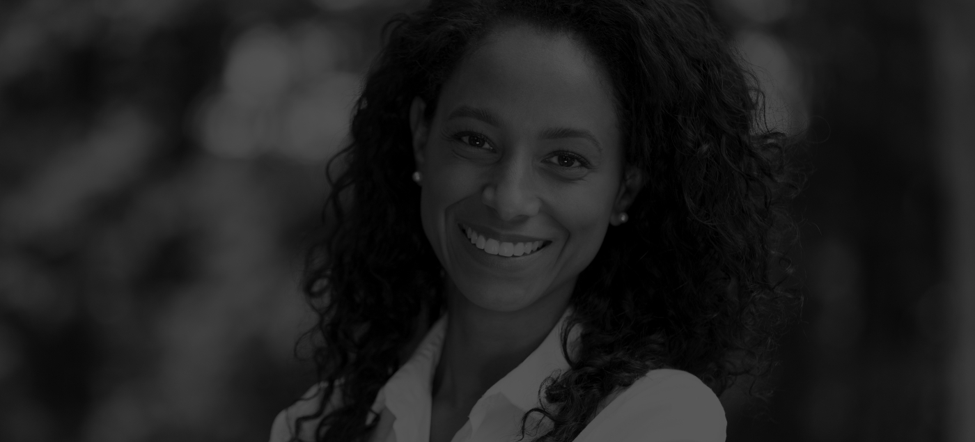 Woman in white collared shirt smiling