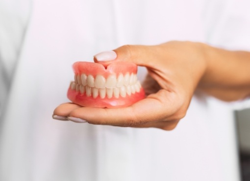 Dentist holding a set of full dentures