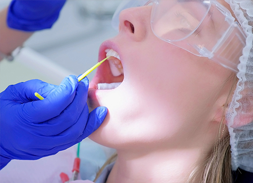 Dental patient having fluoride applied to their teeth