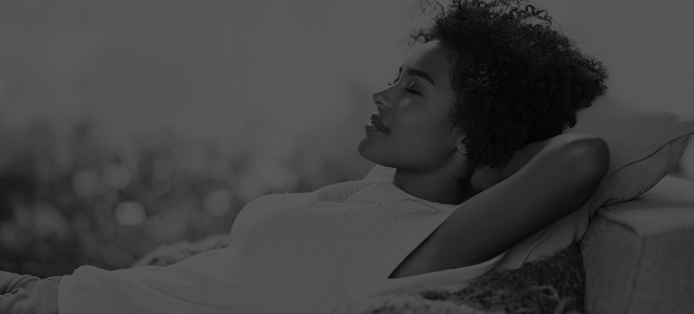 Relaxing woman laying on her back with eyes closed